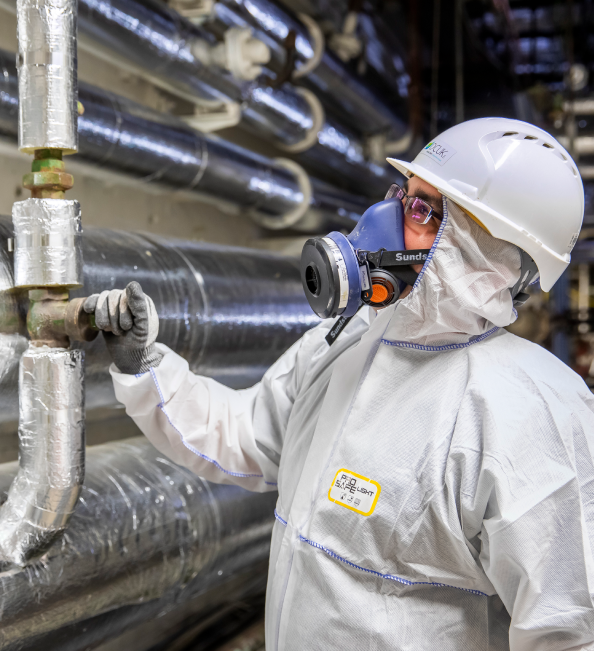 Technician in preventive clothing inspecting for bio threat