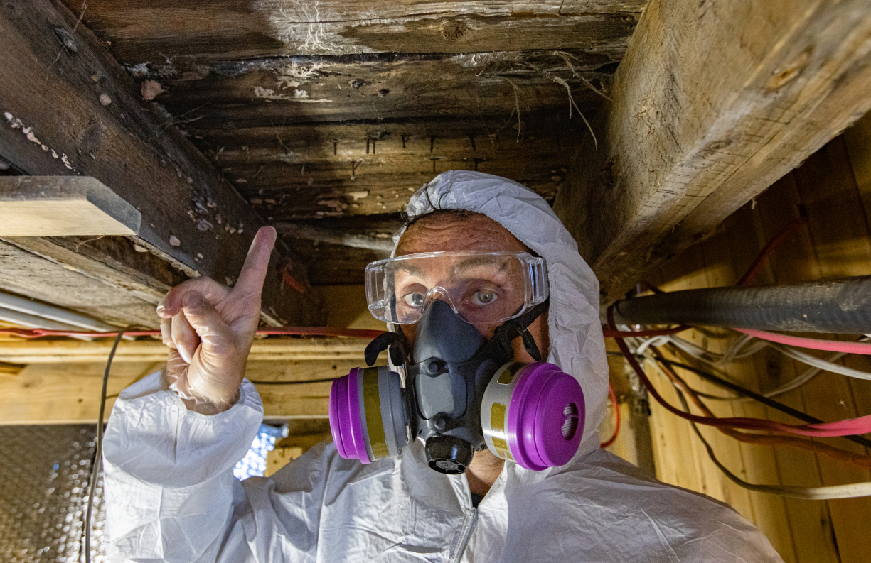Technician in preventive clothing working in moulded building